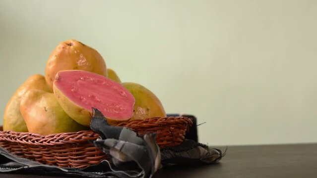 Hand taking a colombian tropical candy made of guava called bocadillo on black wooden table 