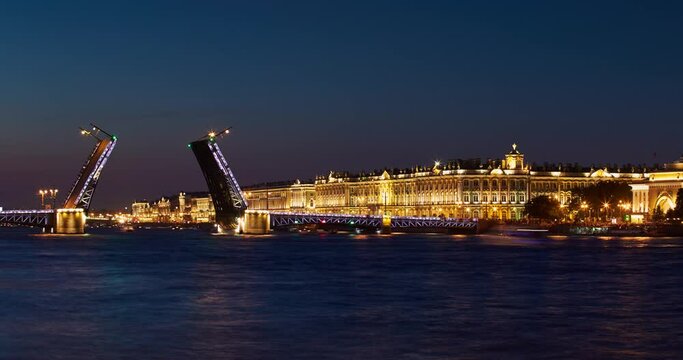Time lapse of opening Palace Bridge in dusk, Winter Palace on a background, a lot of observing tourists, Neva River at sunrise, the Admiralty building, a lot ships and boats