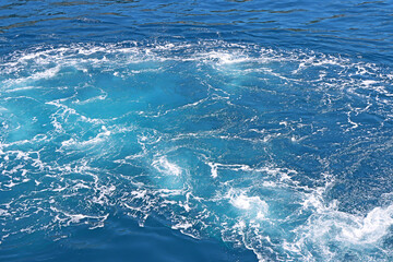 Blue Seawater with sea foam as background