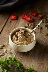 Ají de pepa is a traditional ecuadorian hot sauce made of squash seeds. It’s on a wooden table. 