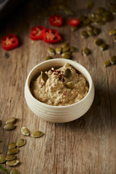 Aj&iacute; de pepa is a traditional ecuadorian hot sauce made of squash seeds. It&rsquo;s on a wooden table. 