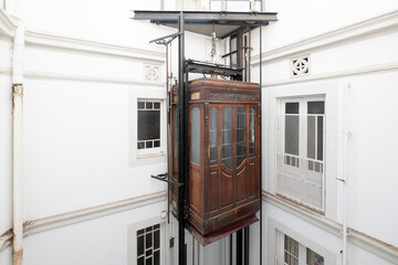 old wooden elevator on a metal shaft, metal elevator in a residential building - obrazy, fototapety, plakaty
