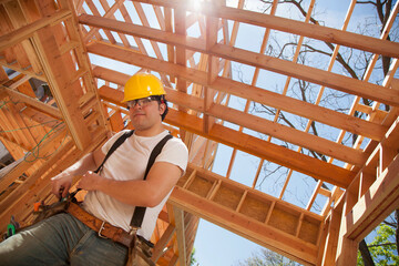 Low angle view of a man working at a residential construction site