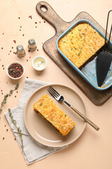 Plate with piece of tasty Shepherd's pie on beige background