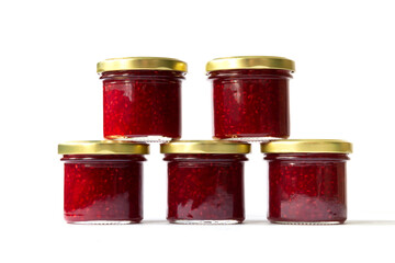 Raspberry jam in glass jars close-up on white background. Packaging for jam.