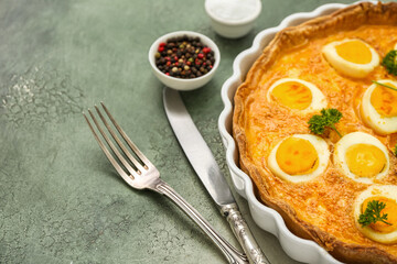 Tasty Easter tart with eggs and cutlery on color background, closeup