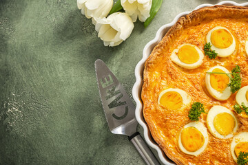 Tasty Easter tart with eggs and spatula on color background, closeup