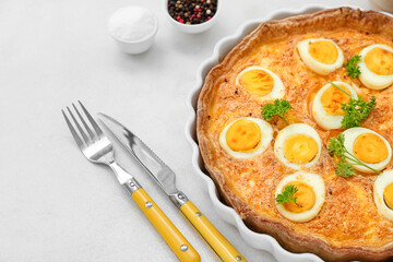 Tasty Easter tart with eggs and cutlery on light background, closeup