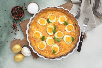 Composition with tasty Easter tart, painted eggs and spices on color background
