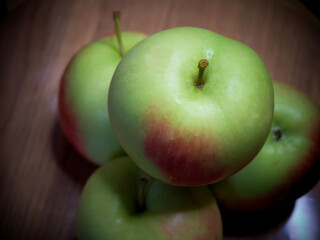 A bunch of juicy red-sided apples, a close-up shot. Ripe fruit.