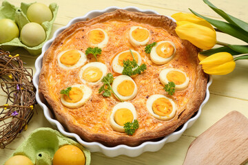Tasty Easter tart with eggs and tulip flowers on color wooden background, closeup