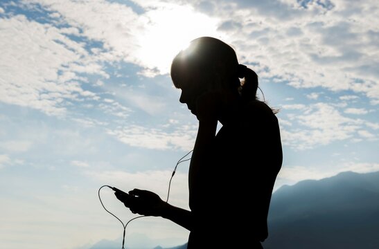 Woman Holding and Using Smartphone in Switzerland.