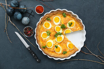 Composition with tasty Easter tart, painted eggs and spices on dark background