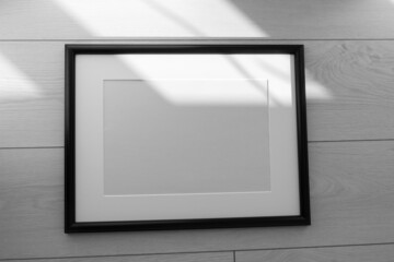 Minimalist black frame mockup on white background with shadow in interior