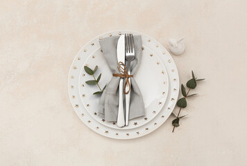 Table setting with Easter rabbit and eucalyptus branches on light background