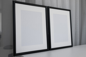 Two minimalist black frame mockup on white background  in interior