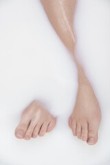 Fototapeta na wymiar Silky and milky. Cropped shot of a womans legs in a milky bath.
