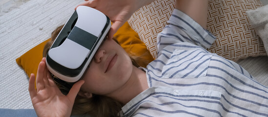 VR relax.European girl using virtual reality to relax and de-stress at home. Girl wearing virtual...