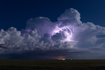 Thunderstorm illuminated by lightning - obrazy, fototapety, plakaty