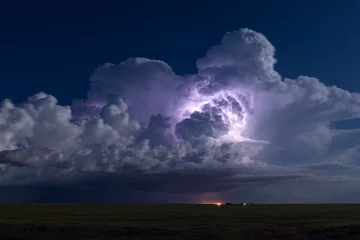 Fotobehang Thunderstorm illuminated by lightning © JSirlin