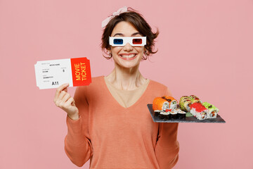 Young fun woman wear 3d glasses watch movie film hold makizushi sushi roll japanese food ticket isolated on plain pastel pink background studio portrait. People emotions in cinema lifestyle concept.