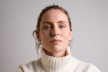 Portrait of young woman looking at the camera isolated on white background.