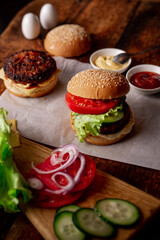 Ingredients for hamburger, cheeseburger. Wooden background. Home cooking hamburger. Food concept. Hamburger day.