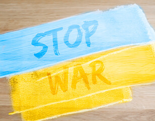 Stop War text on blue and yellow Ukrainian flag. photo