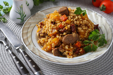 Beef with bulgur and vegetables such as pumpkin, carrots, onions and sun-dried tomatoes