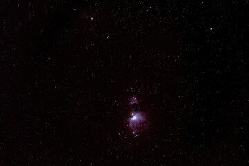 Fototapeta na wymiar Winter night sky with purple Orion nebula many stars visible