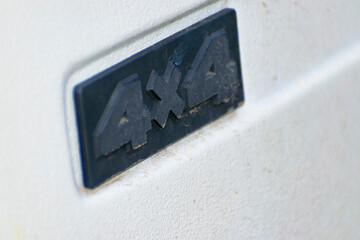 4x4 car logo on a white SUV body. © Anton Vakhrushev