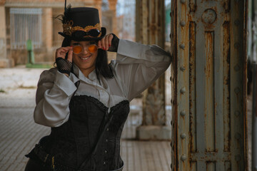 Thick woman dressed in steampunk style in an abandoned train station