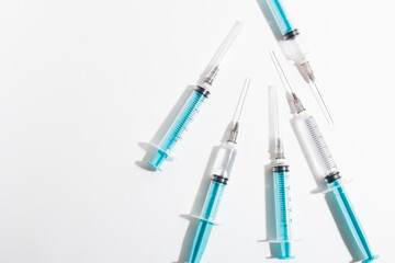 Fototapeta premium Medical syringe on a white background. A syringe for injection. The concept of health and beauty