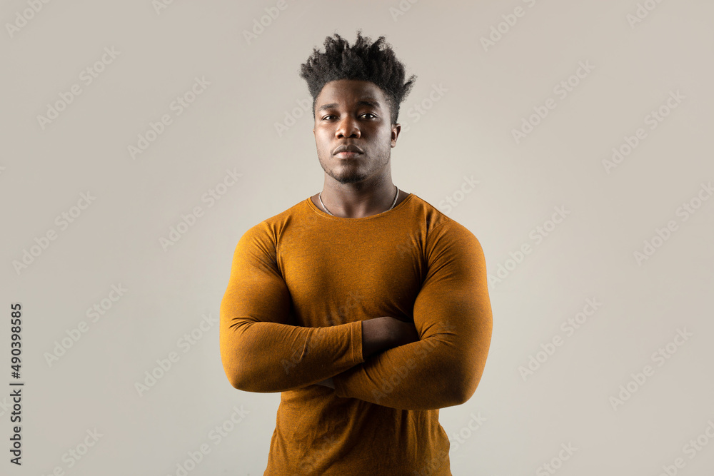 Wall mural serious portrait of an african man with an athletic figure in a sweater