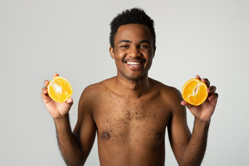 portrait of a cheerful man with oranges 