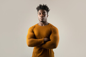 Fototapeta premium serious portrait of an african man with an athletic figure in a sweater 
