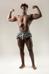 Fototapeta premium african athletic man combing his hair with a sponge 