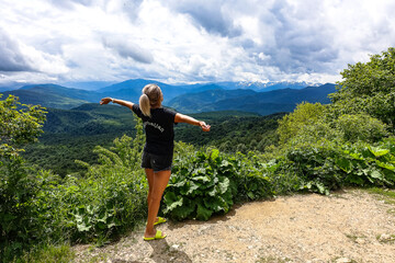 A girl on the background of alpine meadows of the Lago-Naki plateau in Adygea. Russia. 2021.