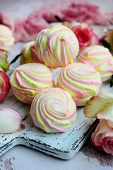 Close-up of a beautiful pink-yellow marshmallow on a gray background. Delicious and sweet dessert