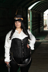 Thick woman dressed in steampunk style inside a freight train car