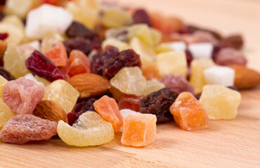 Close up of dried fruits and nuts on a wood table.