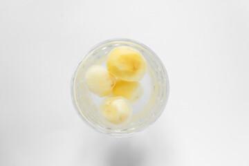 Top view of raw peeled potato vegetables in glass bowl of water. Isolated on white background.
