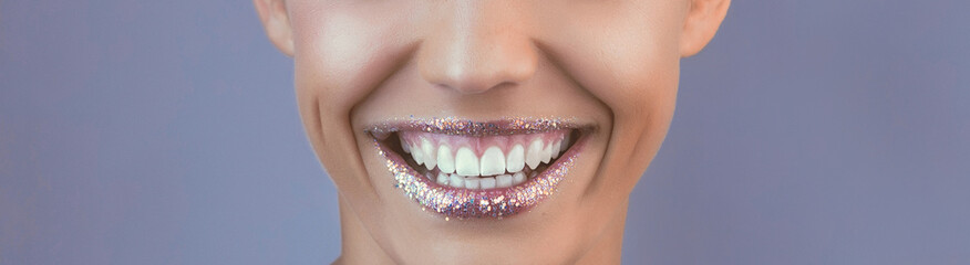 Perfect teeth smile with tinsel lips. Beautiful close up tanned Face of Young Woman with Clean...