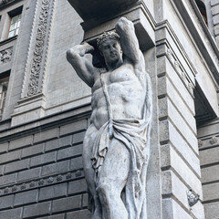 fragment of sculpture Atlanta in the arch of a residential building in the Russian city of St....