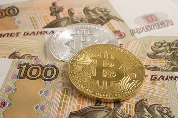 Bitcoin coin on the background of Russian rubles