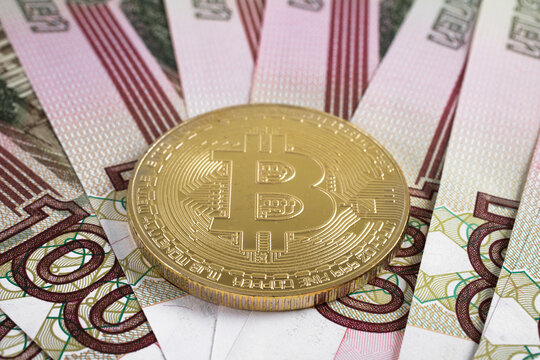Bitcoin coin on the background of Russian rubles