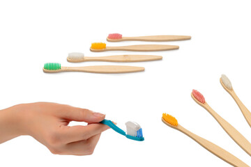 Woman holds toothbrush with toothpaste in her hand isolated on white background.