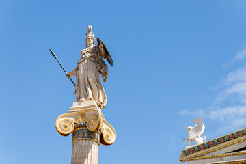Obraz premium Athens, Greece. Column statue of godess Athena, one of the Olympian deities in classical Greek religion, in the modern Academy of Athens
