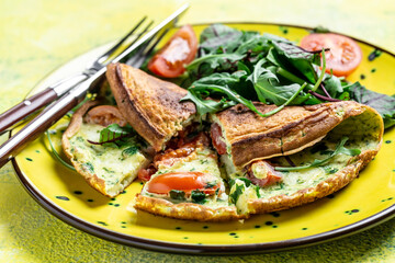 Breakfast Frittata made of eggs, cheese and spinach salad on a yellow plate on a gray background. Ketogenic, keto food. banner, menu recipe top view