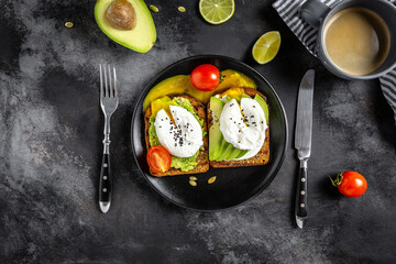 Healthy avocado toasts for breakfast or lunch with rye bread, sliced avocado, arugula, pumpkin and sesame seeds, salt and pepper. Vegetarian sandwiches. Plant-based diet. Whole food concept